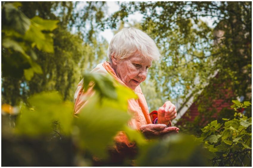 A senior woman enjoying leisure time picking leave