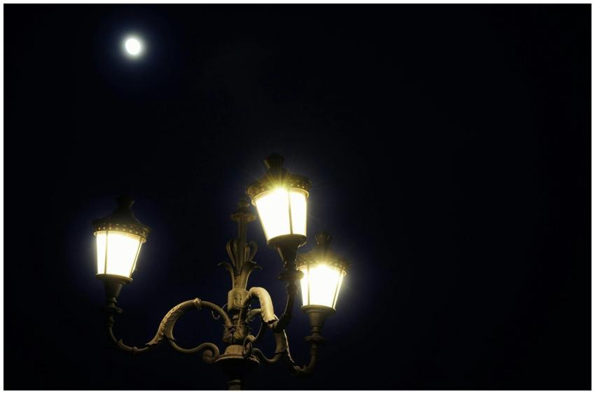 A classic street lamp illuminates the night under