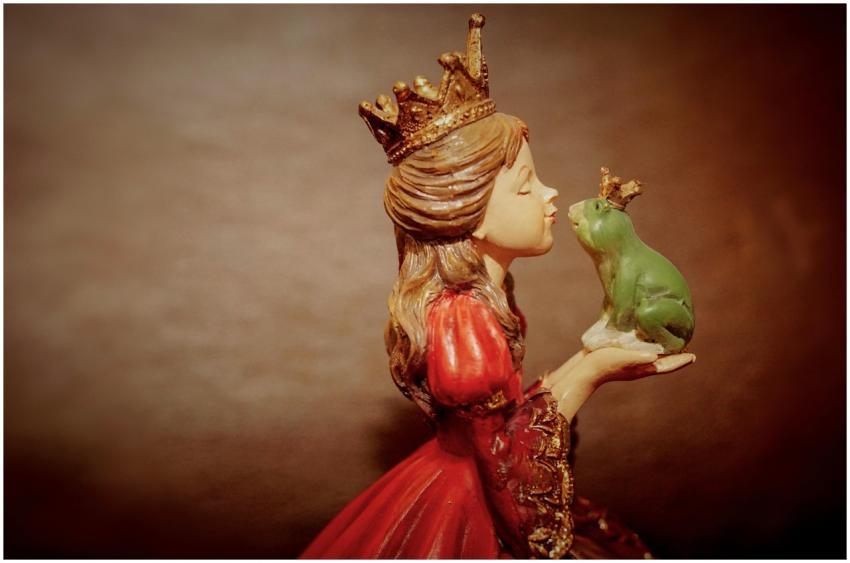 Side view of a ceramic princess figurine holding a