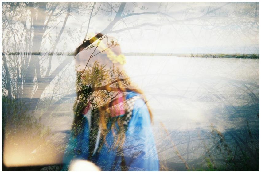 Artistic double exposure with a girl and trees by