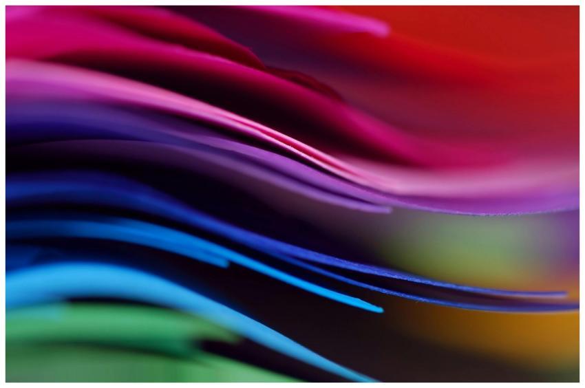 Dynamic close-up of layered colorful paper creatin