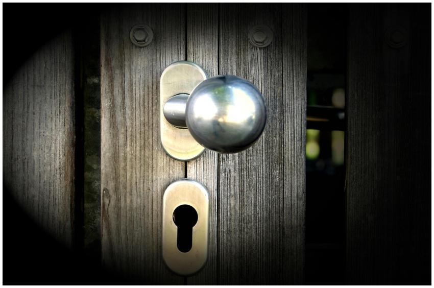 Close-up view of a metal doorknob and keyhole on a