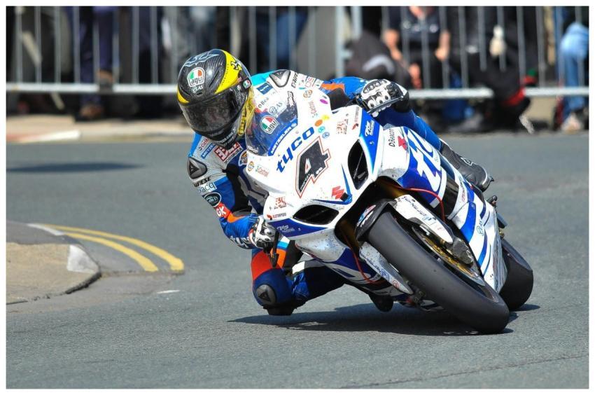 Professional motorcycle racer navigating a sharp t