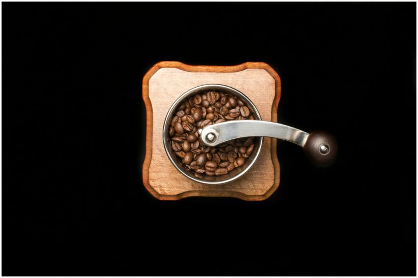 Close-up photo of roasted coffee beans in a wooden
