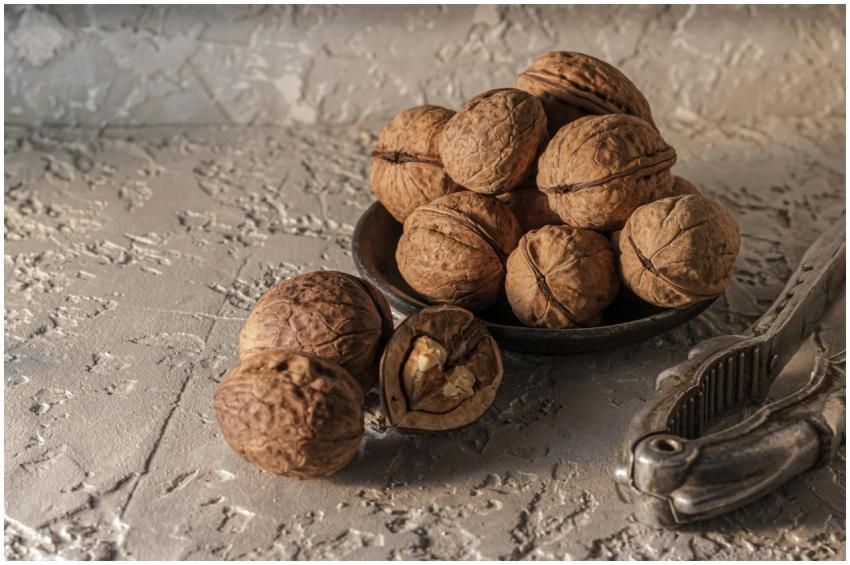 A rustic presentation of walnuts in a dish with a