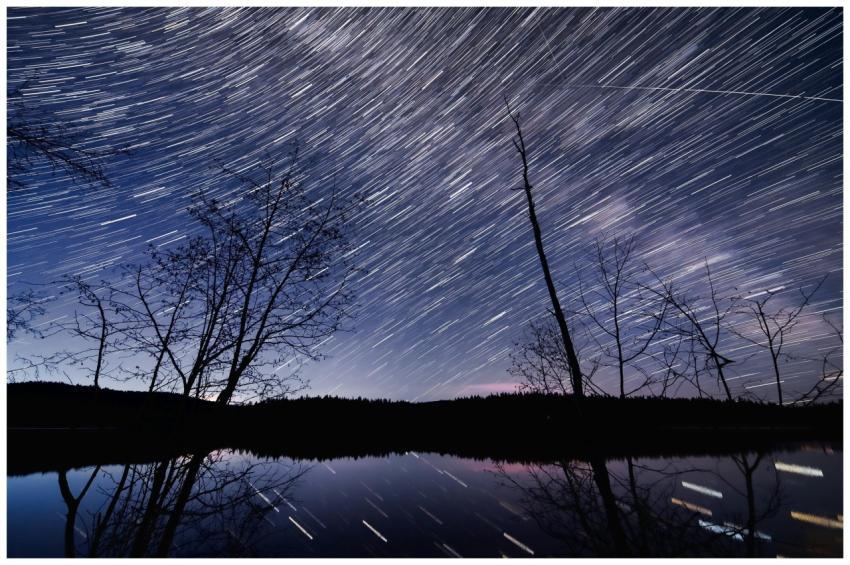 Captivating star trails casting reflections on a t