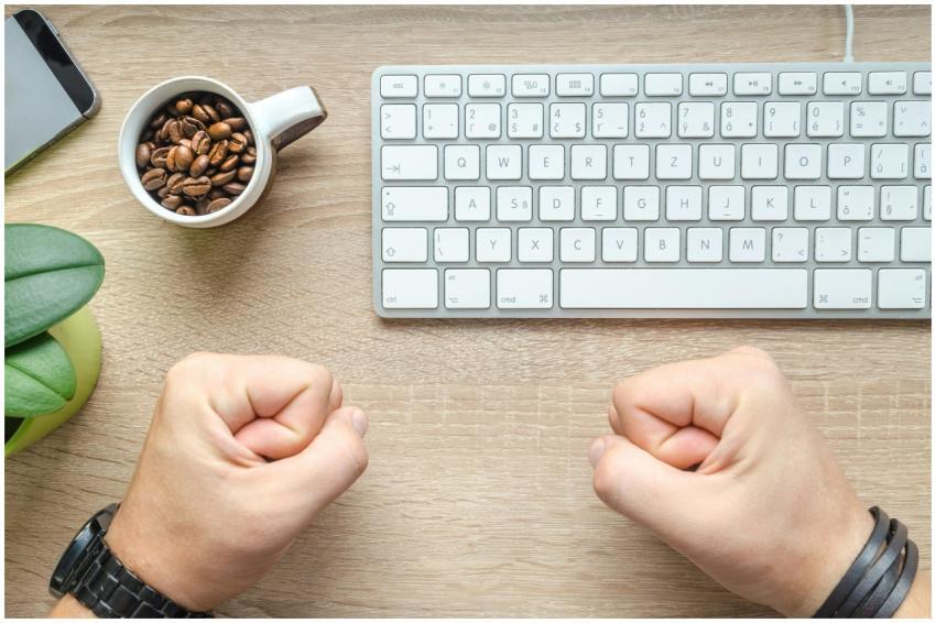 Top view of a desk with coffee beans cup, keyboard