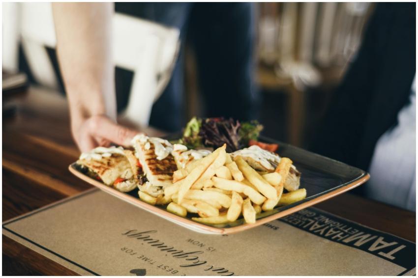 Close-up of a platter with French fries and sandwi