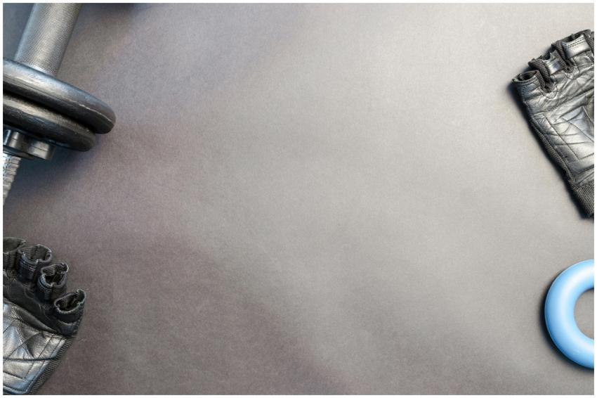 A flat lay of gym essentials including a dumbbell,