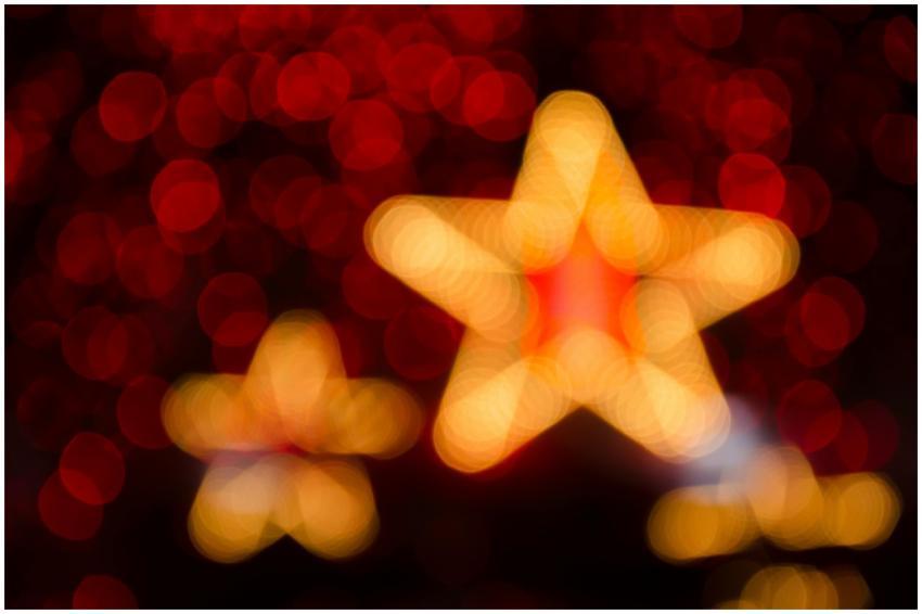 Blurred gold and red star-shaped lights creating a