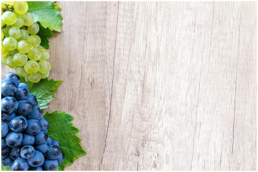 Colorful grapes on a wooden board, perfect for fre