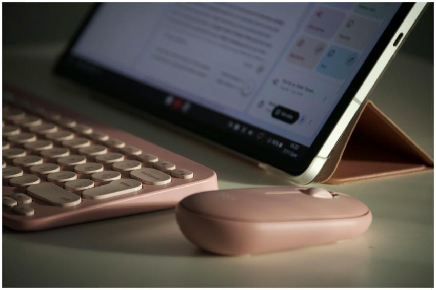 Stylish digital workspace setup with a pink keyboa