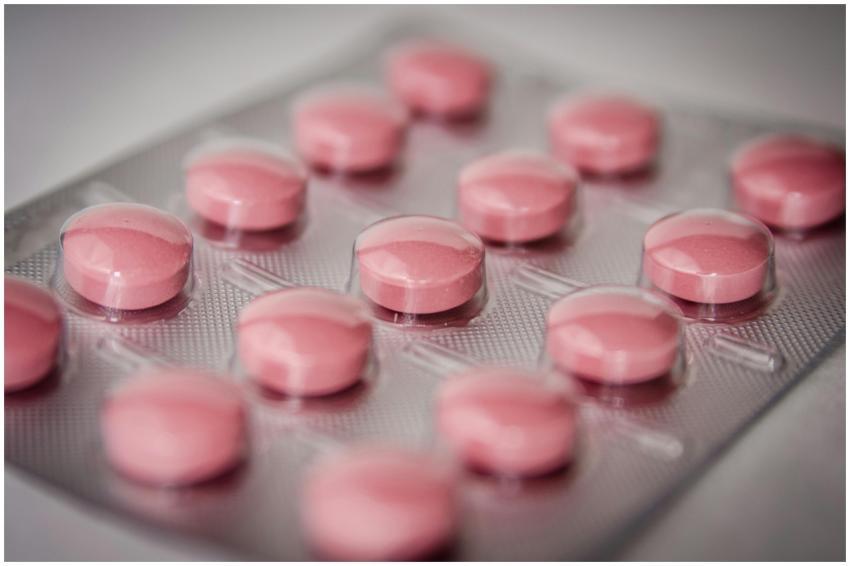 Pink tablets in a blister pack, emphasizing health