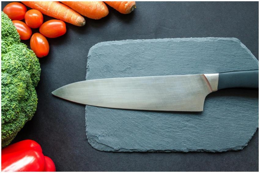 Close-up of fresh vegetables with a chef's knife o
