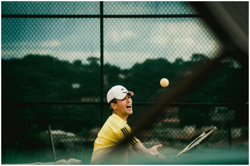 Dynamic action shot of a young man playing tennis