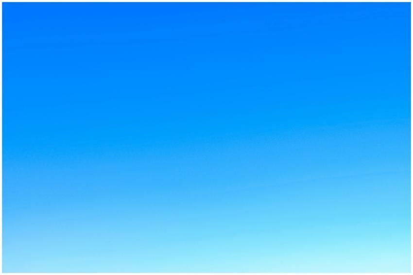 A serene view of a vibrant clear blue sky with a s
