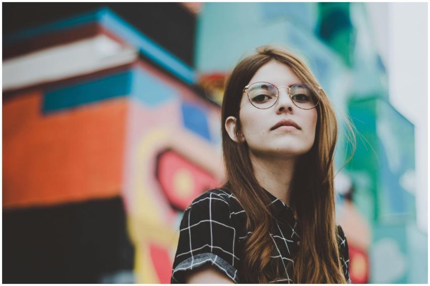 Portrait of a fashionable woman with glasses posin