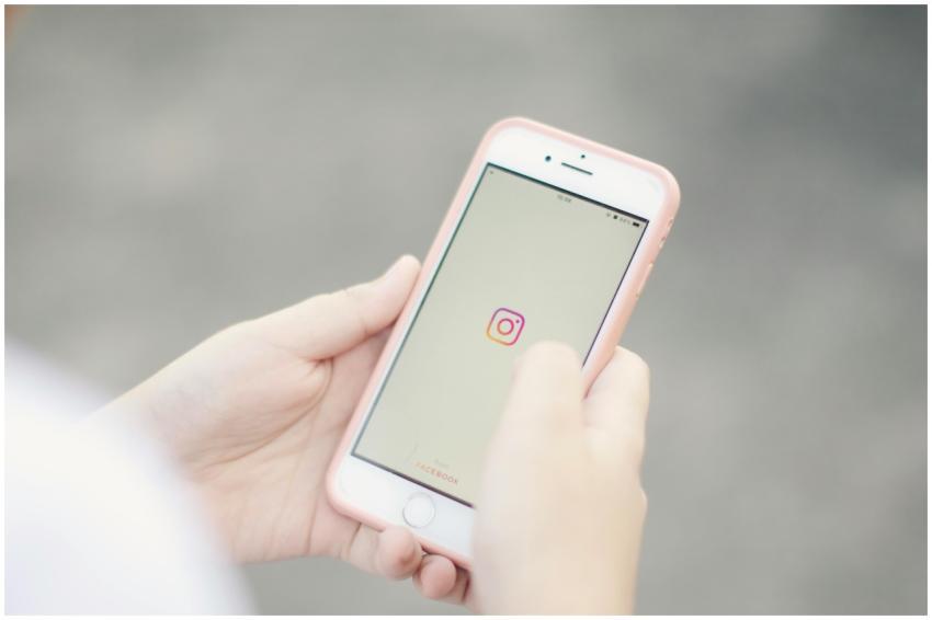 Hands holding a smartphone with the Instagram app