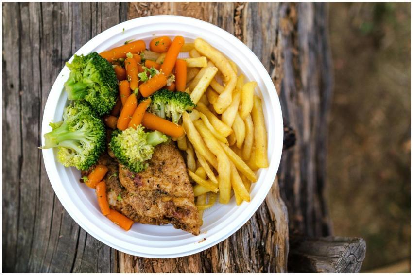 A delicious plate of chicken, fries, and fresh veg
