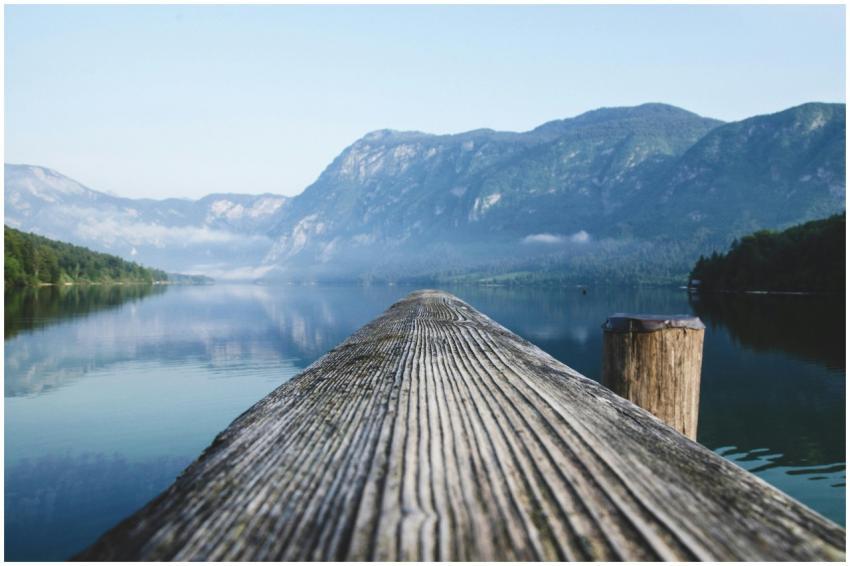 Serene view of a mountain lake from a wooden dock