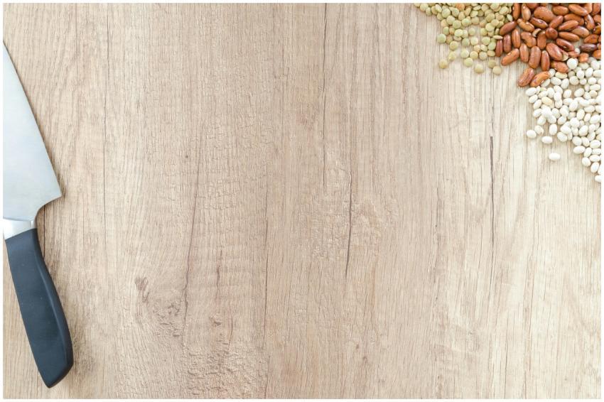 A rustic wooden surface with knife and an assortme