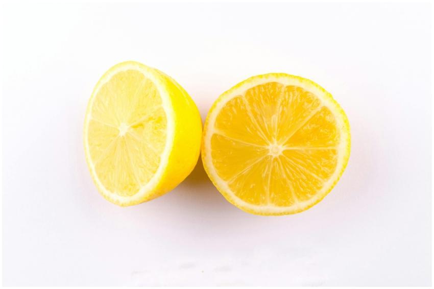 Close-up of fresh, juicy lemon halves on a clean w