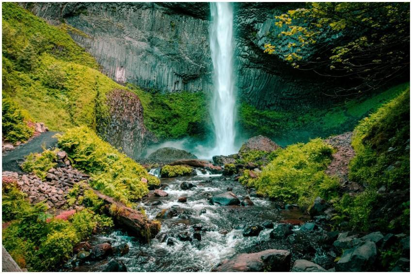 Majestic waterfall cascading down rocky cliff surr