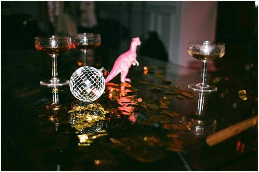 A celebration scene featuring glasses, disco ball,