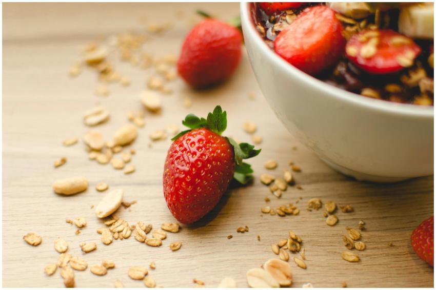 A close-up of a fresh strawberry breakfast bowl wi