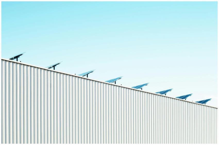 Corrugated steel building with solar panels under