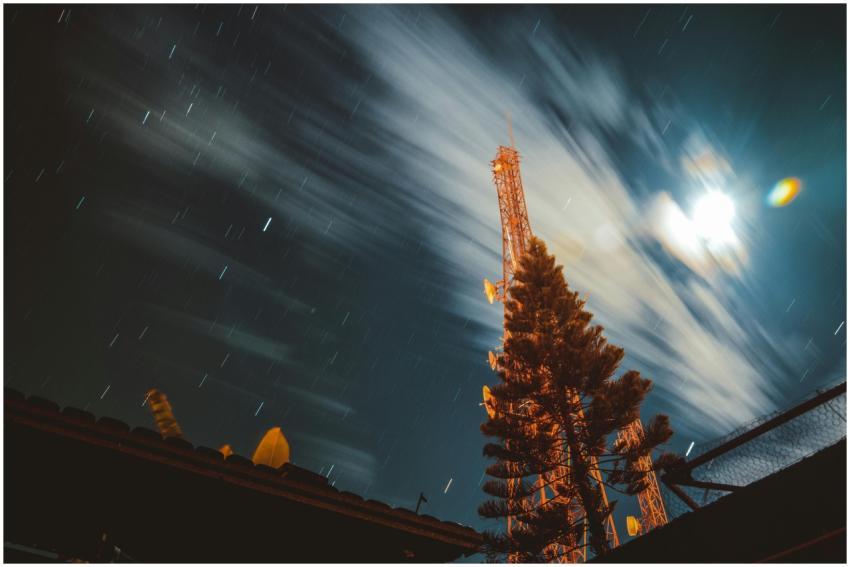 Long exposure of a night sky featuring an antenna