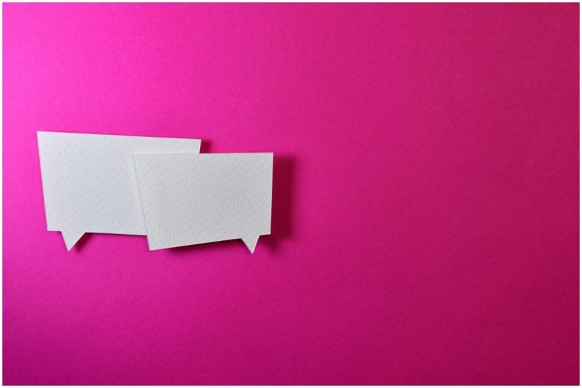 White speech bubbles on a vibrant pink background