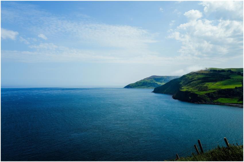 Peaceful coastal landscape with blue ocean and gre