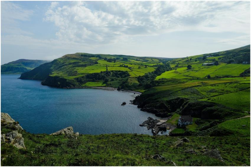 Idyllic view of lush green hills meeting tranquil