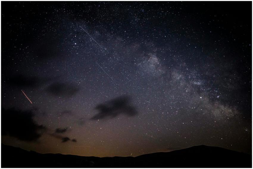 A stunning night sky showcasing stars, clouds, and