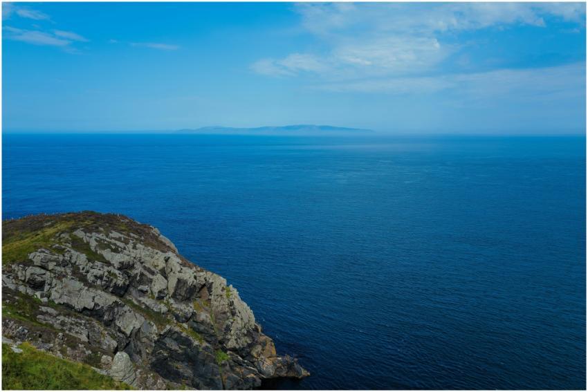 Bright coastal landscape featuring clear blue sea