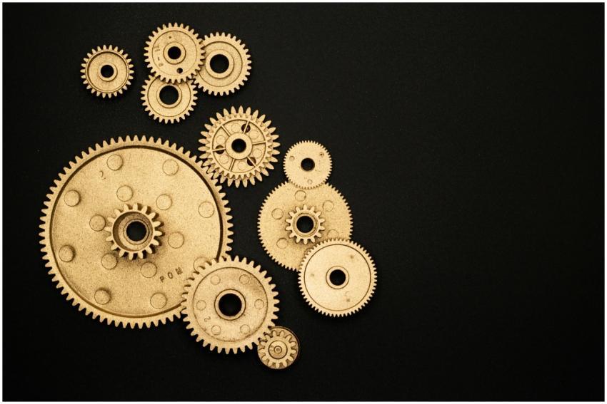 Close-up of gold gears arranged on a black backdro