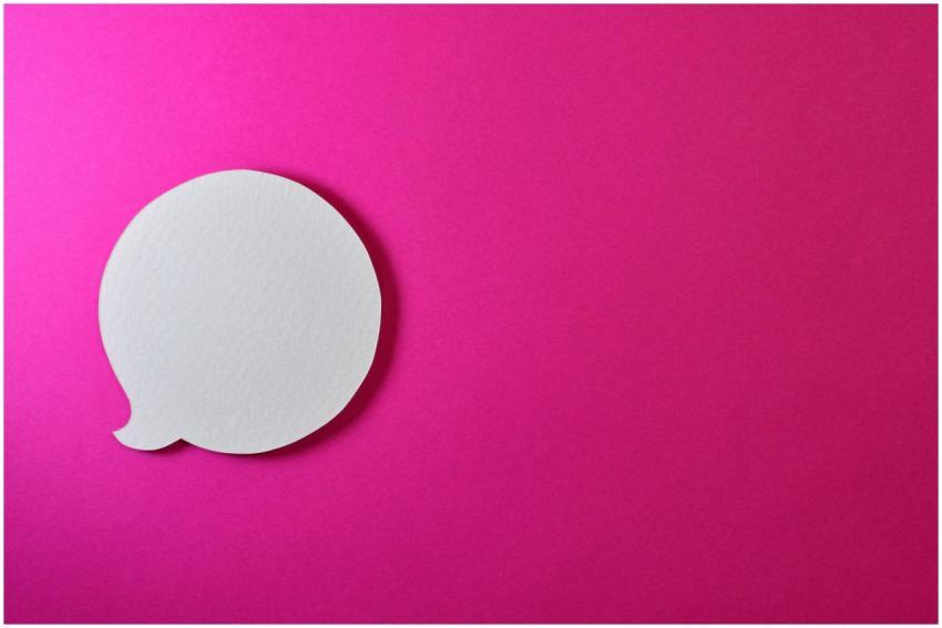 Minimalist pink background with a white speech bub