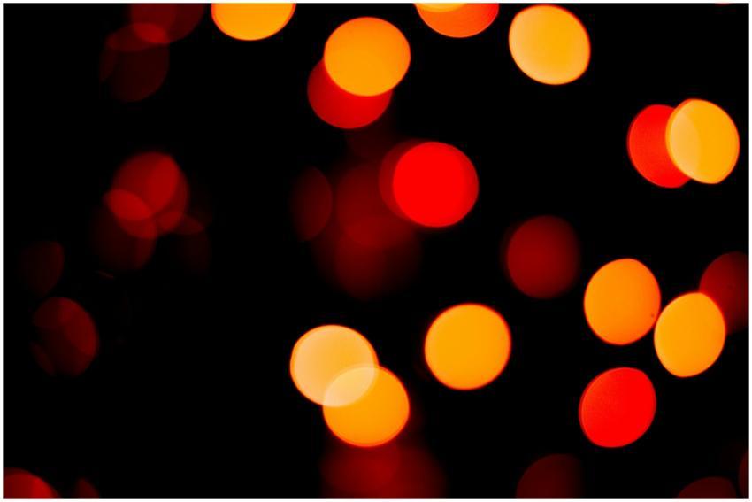 Vivid bokeh lights in red and orange create a capt