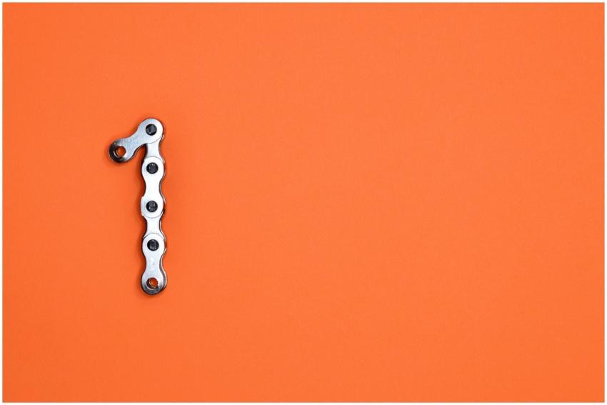 Metal chain forming the number one on an orange ba