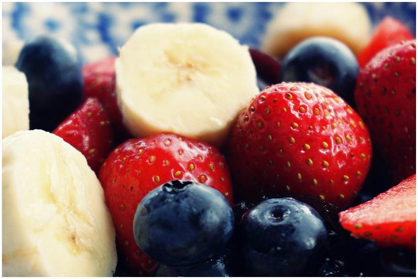 Close-up of fresh bananas, strawberries, and blueb