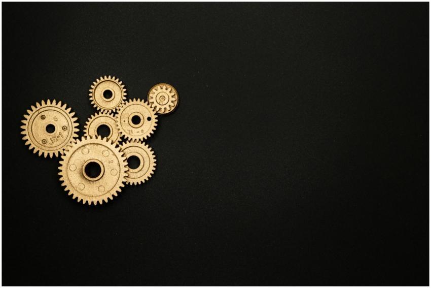 Gold gears on a black background representing indu