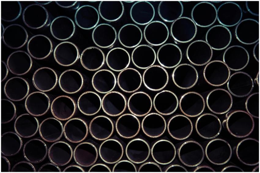 A detailed macro shot of stacked metal tubes formi