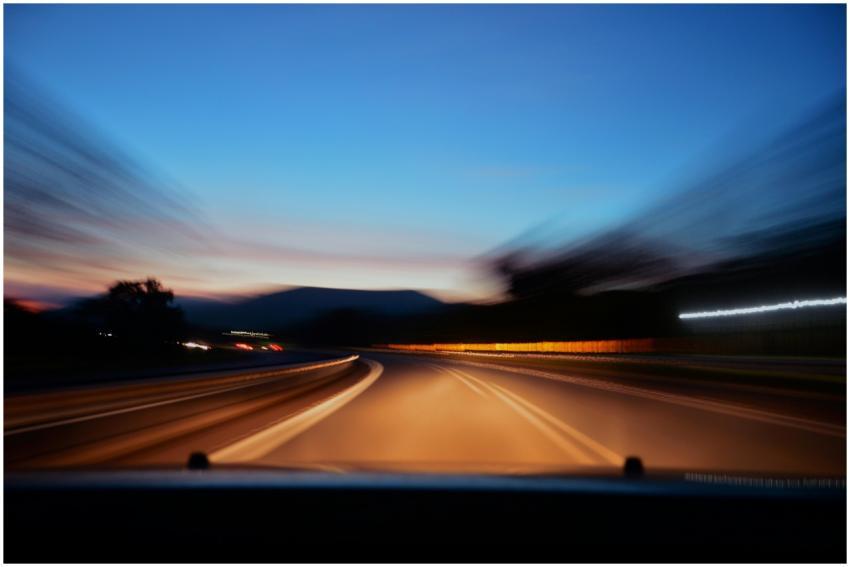 Blurred highway scene with car lights at twilight,