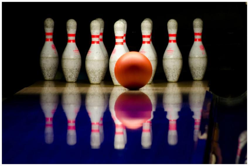 A striking close-up of a bowling ball approaching