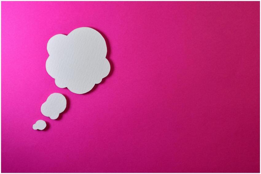 Paper thought bubble over bright pink background,