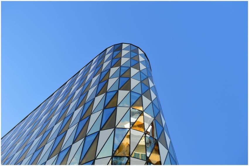 A modern building with a geometric glass facade un