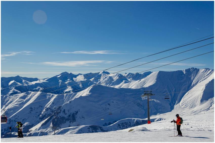 Breathtaking view of skiers and snow-covered peaks