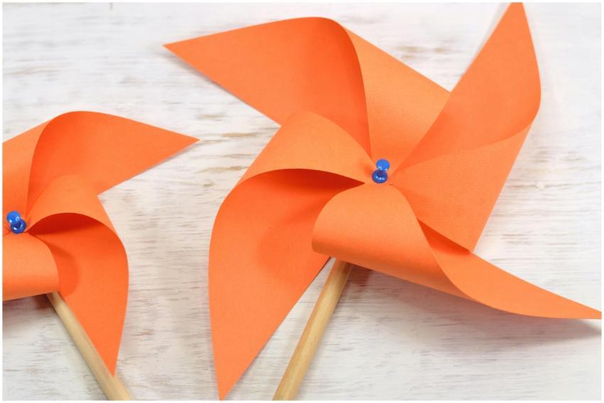 Close-up of vibrant orange origami pinwheels with
