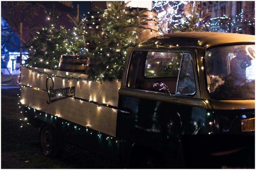 A vintage truck adorned with Christmas lights and